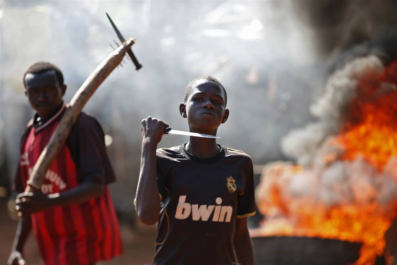 politics-war:
“A boy brandishes a knife as he stands in front of a barricade during a demonstration after French troops opened fire at protesters blocking a road in Bambari, Central African Republic
”