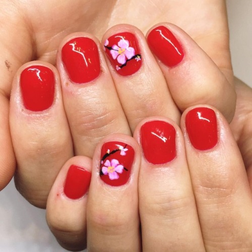 Cherry blossoms on cherry red 🌸 #cherryblossoms #floralnailart...