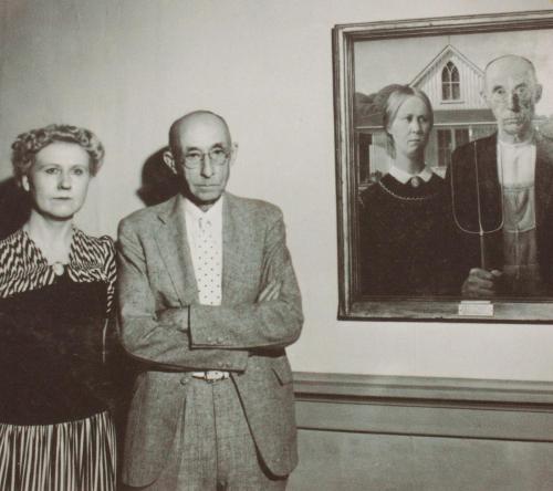 The models of “American Gothic” stand next to the painting - …painting by Grant Wood, 1930 -