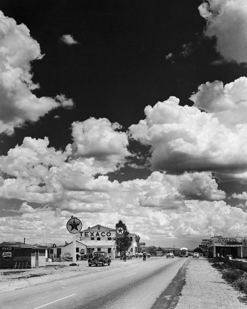 A scenic view of billowing clouds and a Texaco gas station along...