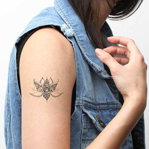 Ornamental lotus tattoo on the right upper arm. >>> Buy...