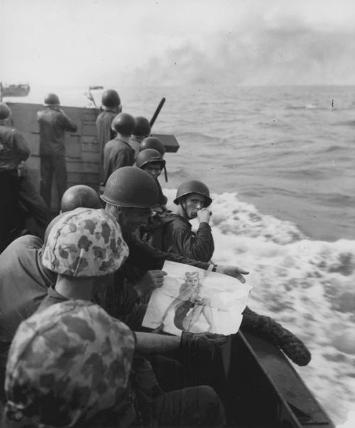 warhistoryonline - US Marines with a pin-up girl picture in a...