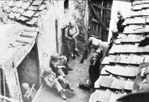 ww1ww2photosfilms - German paratroopers rest in a courtyard...
