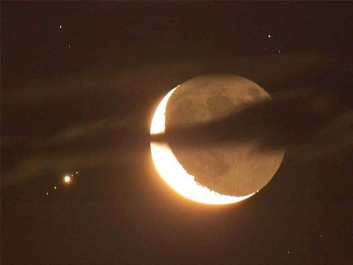 sixpenceee:Jupiter and four of its moons, next to Crescent Moon....