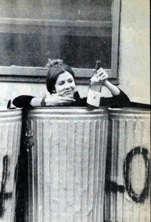 oldschoolcelebrities:Carrie Fisher in the trash with a bottle of...