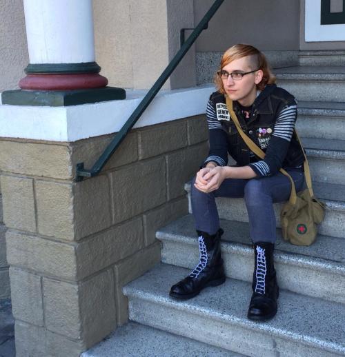 [butch trans dyke sitting on the steps of her girlfriend’s...