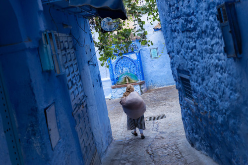 Morocco.chefchaouen.A woman walks in the old town medina