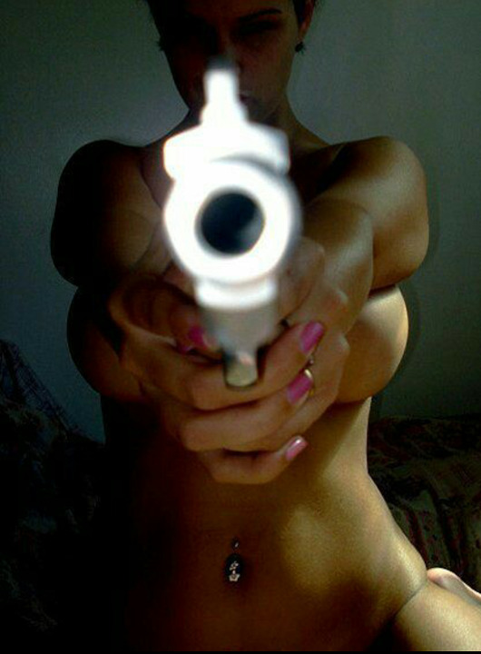 Это - фотография женщины, целящейся в фотографа из оружия