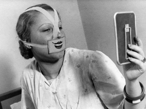 lostinhistorypics - Woman in the 1930’s going through an...