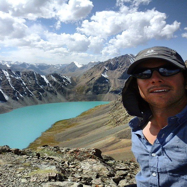 Summiting a 3,800m pass in the Terimtor mountains. Alakjol Lake in the background is at 3,532m. Nearly eight hours of trekking to ascend from 2,358m to 3,800m. (at Altyn Arashan)