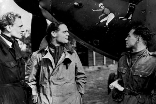 Squadron Leader Douglas Bader by the nose art of his Hurricane...