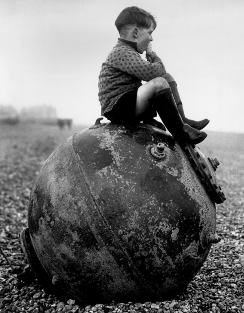 bailey505 - Boy sitting on a sea mine, Kent, England, 1945.