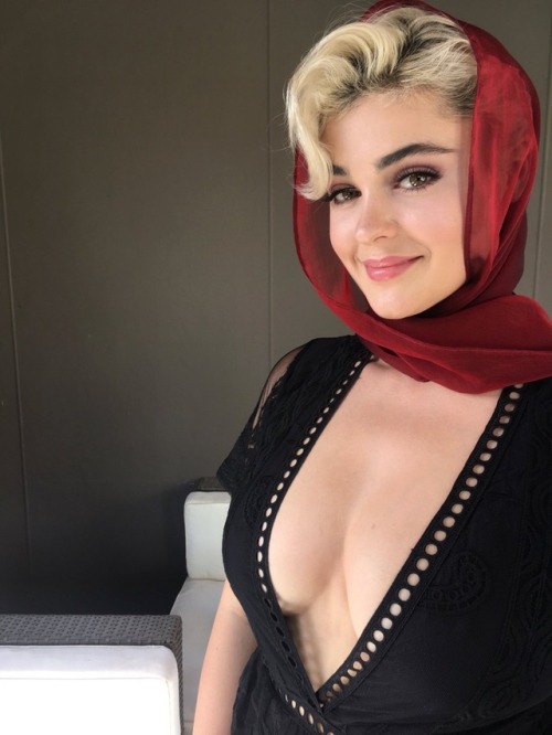Stefania Ferrario in a low-cut black dress and a red scarf. Such...