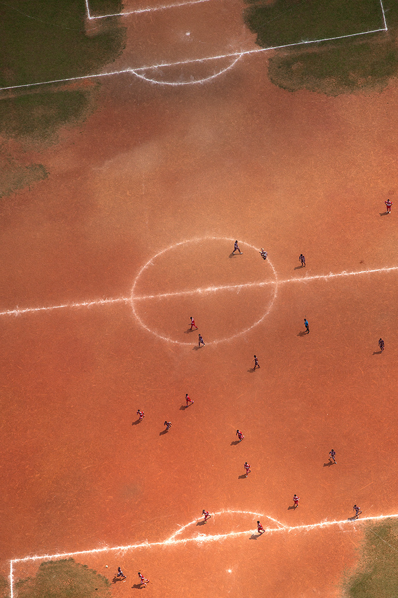 Ground From Above - Terrão de Cima by Renato Stockler “A ‘terrão’ (earthen field) is an oasis in the urban landscape. The reddish tone of a soccer field turns into a stage for resistance of popular soccer. These fields are increasingly rare to be...