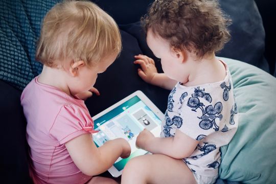 Babies playing with a tablet computer