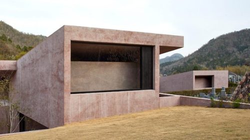A pink pigmented concrete building designed by David...