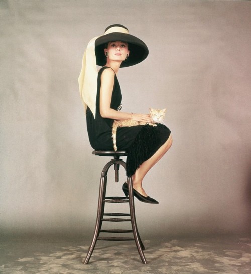 wehadfacesthen - Audrey Hepburn, 1961, wearing a dress and hat...