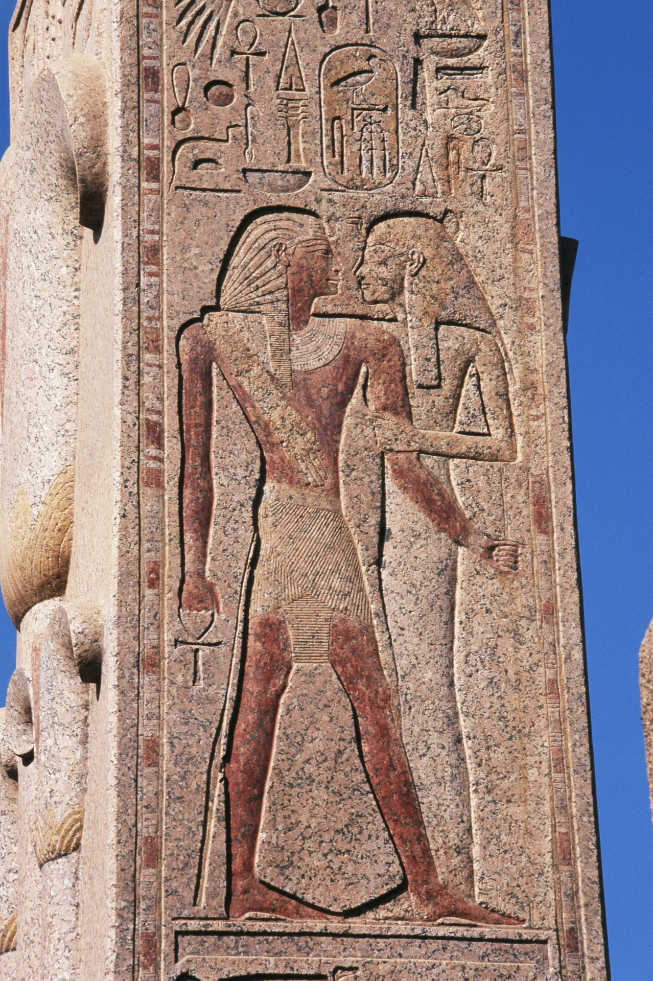 King Thutmose III embraced by the goddess Mut, detail from the pillar of Upper Egypt, one of the two granite heraldic pillars erected by Thutmose III in the front of his Hall of Annals at Karnak.