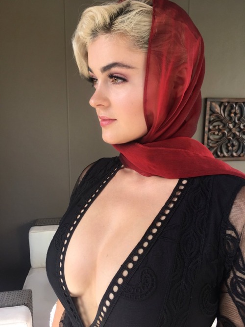 Stefania Ferrario in a low-cut black dress and a red scarf. Such...