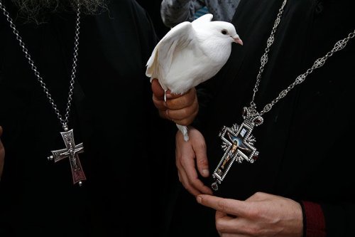 globalchristendom:Greek Orthodox clergy with a dove in...
