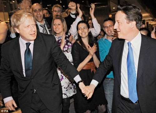 David Cameron, re-elected Prime Minister of the UK, walks hand...
