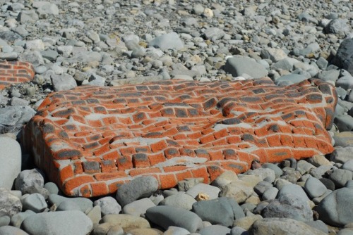 sixpenceee:Entire brick wall smoothed out by the ocean 