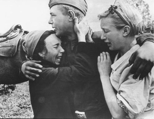 A Soviet soldier embraces family members before being deployed...