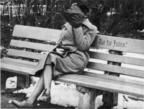 historicaltimes:A woman sits on a park bench marked “Only for...
