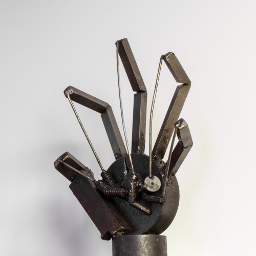 Hand metal sculture made by a prisoner in a soldering / art...