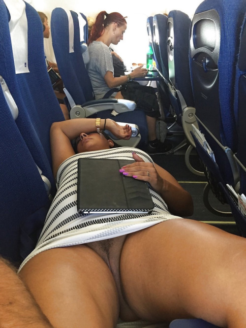 In a short dress and showing her pussy inside an airplane