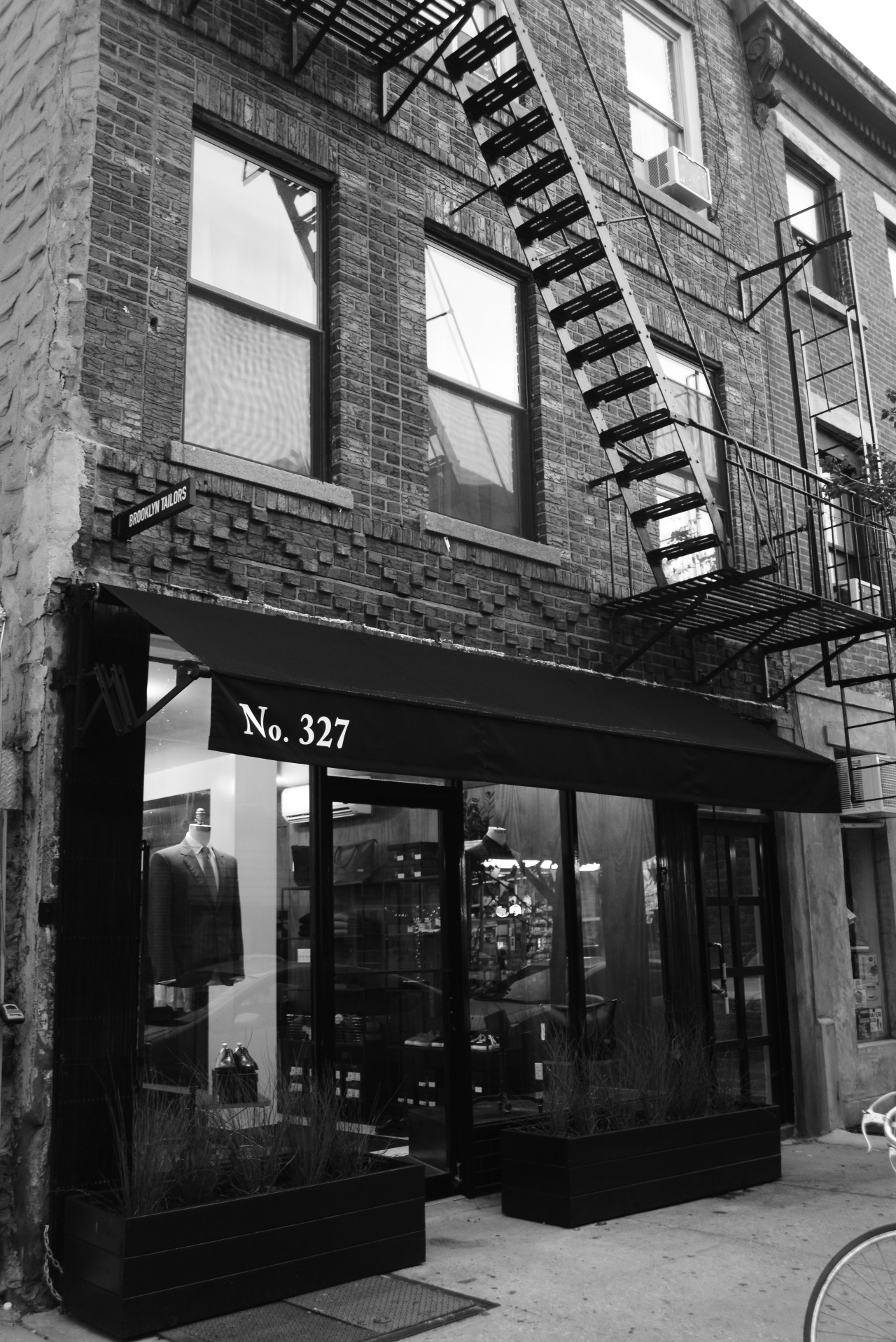Black and white image of the Brooklyn Tailors storefront in Williamsburg