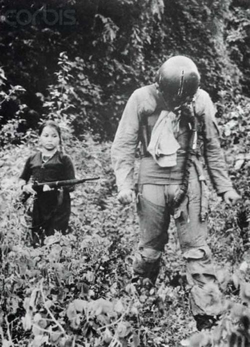 historicaltimes - A young Vietnamese girl escorts an American...