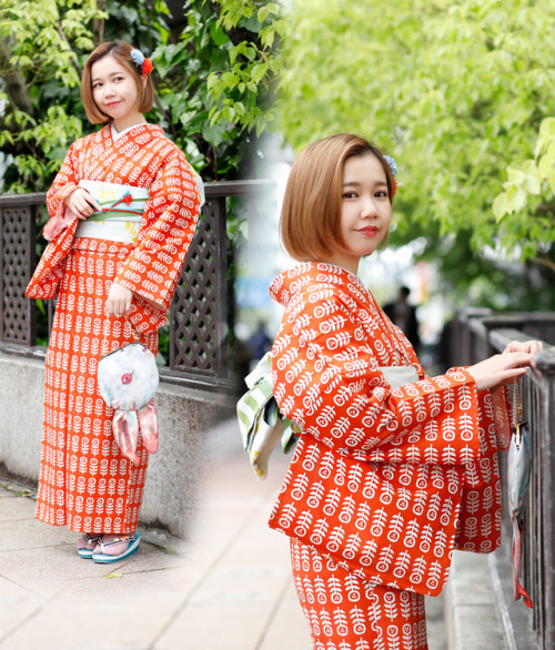 This kimono is a rich orange covered with a simple grid pattern...