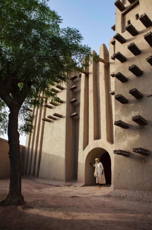forafricans - A man stands outside a mosque. Djenne, Mali....