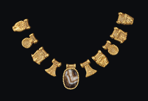 Ten south Arabian gold pendants, with a banded agate...