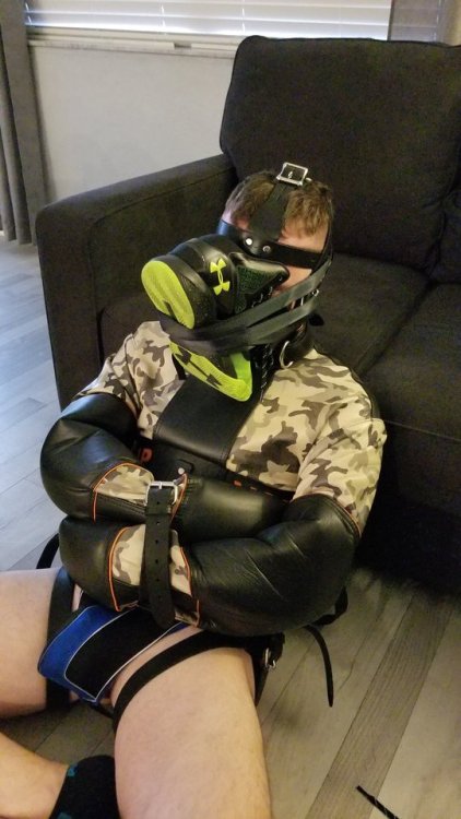 alphamajor47:Caged, muzzled and his straightjacket....