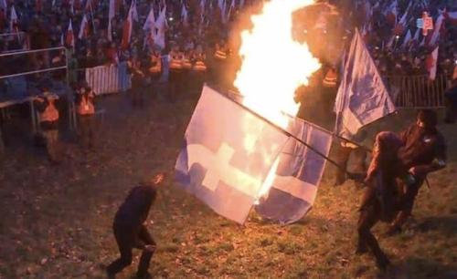 Polish nationalists burned Facebook flags to protest being...