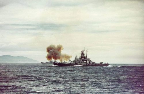 warhistoryonline - USS Indiana (BB-58) fires a salvo from her...