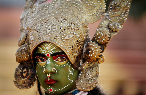 artofprayer - A woman dressed as Kali, a Hindu goddess, in a...