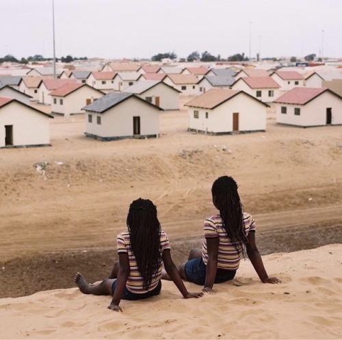 forafricans - Two girls in matching clothes sit on a hill of...