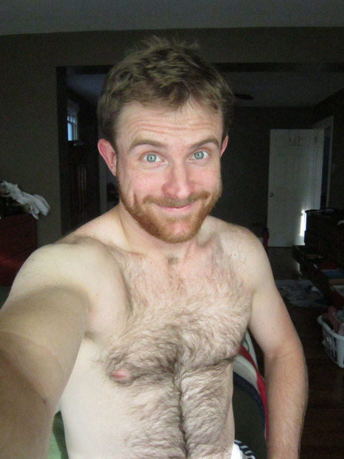 Hairy, shirtless dude in his apartment