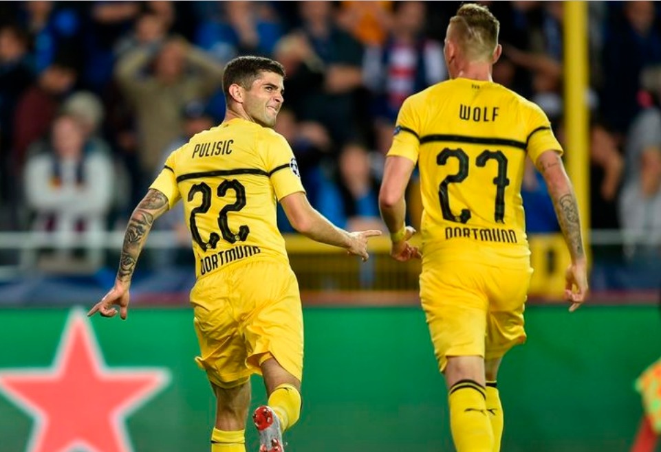 Pulisic and Wolf celebrate the goal
