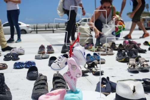 absolutelyiris:Citizens in Puerto Rico laid shoes at the San...